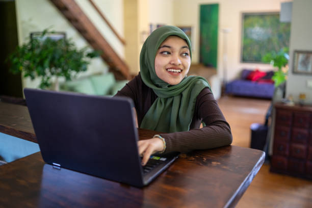 istock A woman with a hijab using laptop, smiling 2174466015