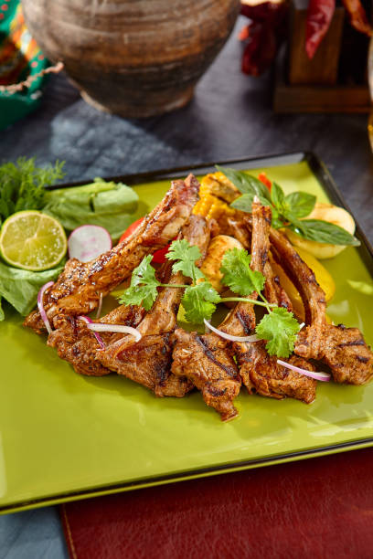 istock Grilled Lamb Chops with Vegetables on a Green Plate 2174467956