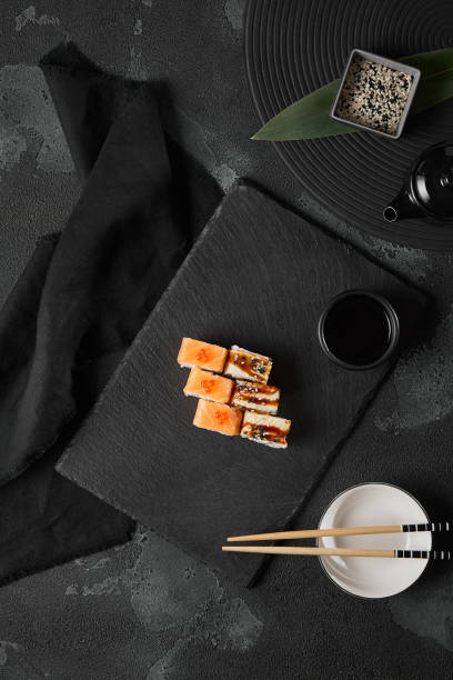istock Elegant Salmon and Eel Sushi Roll with Minimalist Dark Aesthetic 2174471140