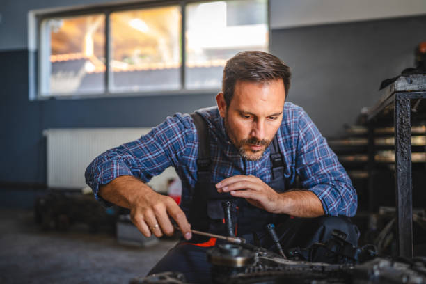 istock Car mechanic inspect car engine with tool at garage 2174472307