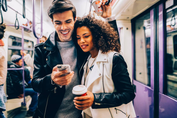 istock Couple drinking coffee while travelling in the subway 2174475115