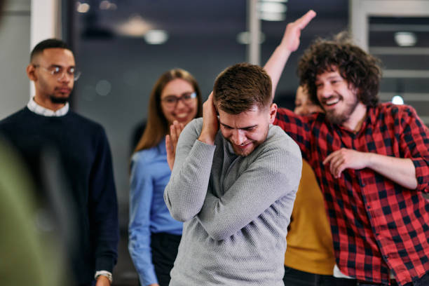 istock A group of young business people have fun playing interesting games while taking a break from work in a modern office. Selective focus 2174477640