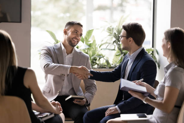 istock Happy confident handsome businessmen shaking hands on meeting 2174479976
