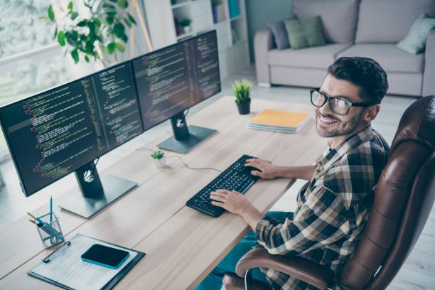 istock Photo of positive cheerful programmer wear spectacles smiling web engineering indoors workplace workshop home 2174480071