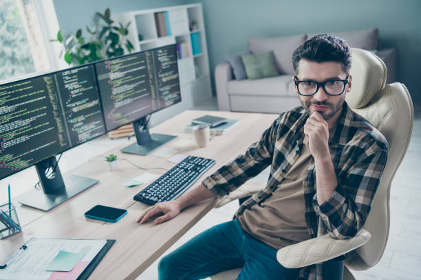 istock Photo of busy smart programmer wear spectacles arm hand chin testing modern device system indoors workplace workshop home 2174480094