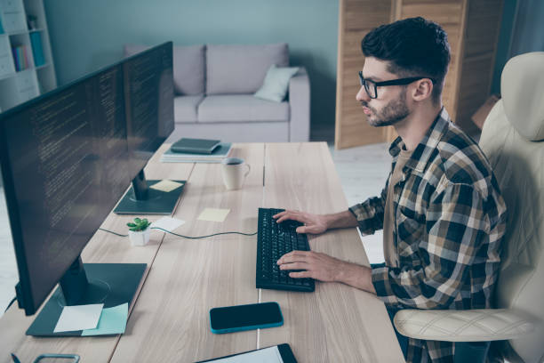 istock Photo of busy serious programmer wear spectacles developing application indoors workplace workshop home 2174480139