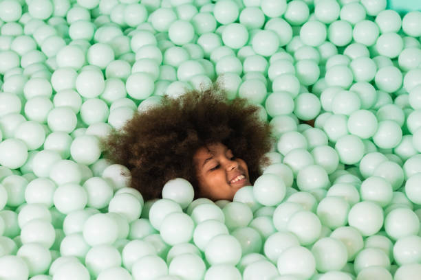 istock Cheerful child in ball pit 2174480705