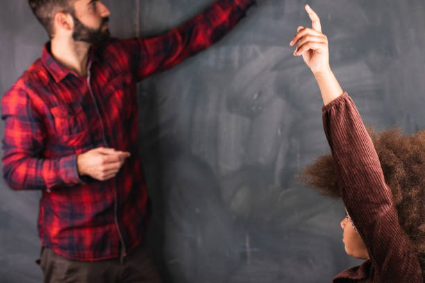 istock Multiracial teacher and pupil in classroom at math lesson 2174480867