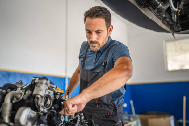 istock Car mechanic work on a car engine in an auto repair workshop 2174483217