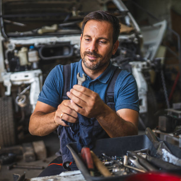 istock car mechanic holding cloth clean tools with open engine in background 2174483714