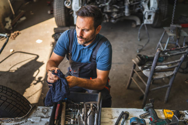 istock car mechanic holding cloth clean tools with open engine in background 2174483777
