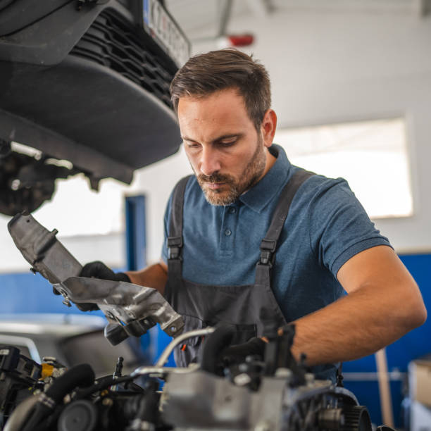 istock Car mechanic work on a car engine in an auto repair workshop 2174484443