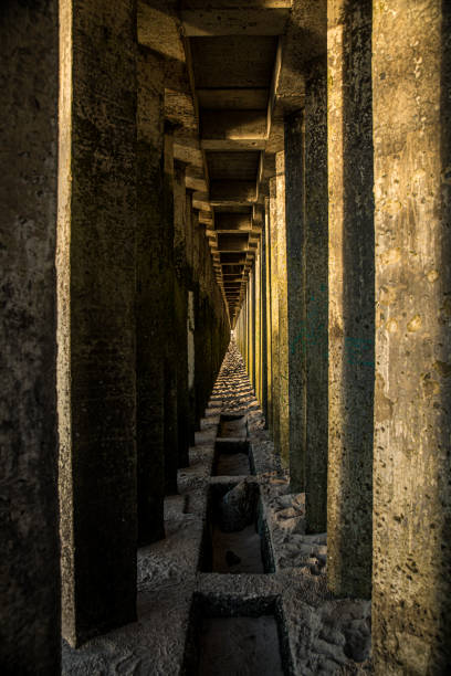 istock A long hallway has columns and a drain in its center 2174484812