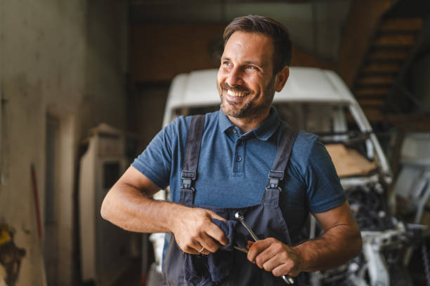 istock car mechanic holding cloth clean tools with open engine in background 2174485090