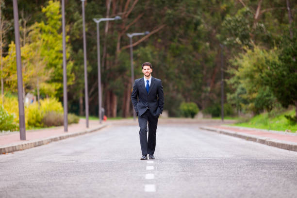 Businessman walking on the road line