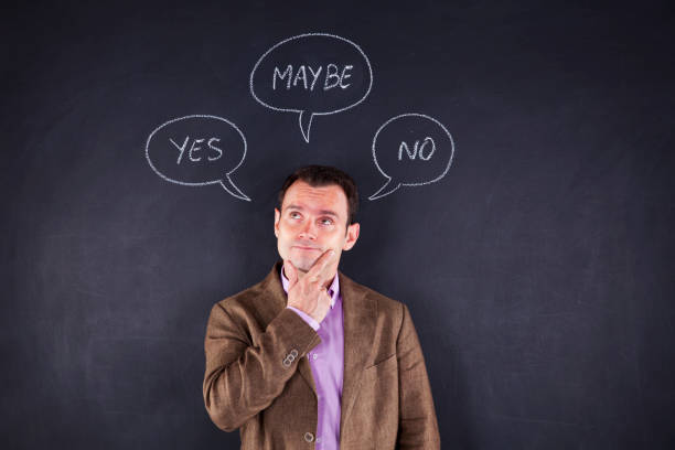 istock man engages in a unique form of expression, utilizing three speech balloons that read 'Yes,' 'No' and 'Maybe' 2174486955