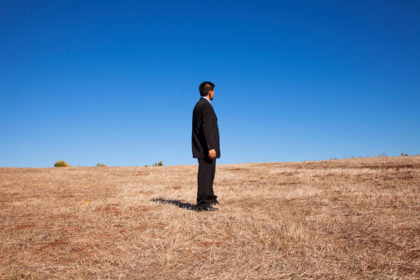 businessman standing alone at the field