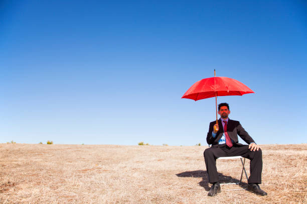 istock Businessman with a red umbrella 2174487519