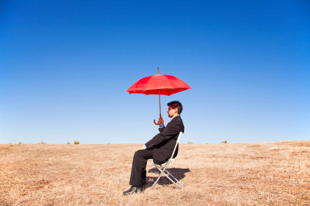 Businessman with a red umbrella