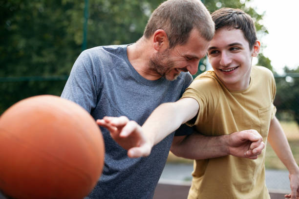 istock Happy father and son practicing basketball 2174489135