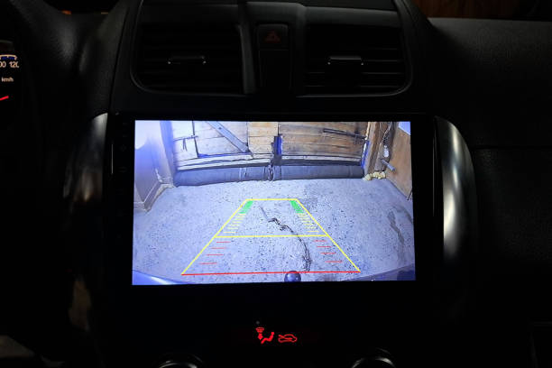 istock Installation of a modern multimedia system with a rear-view camera on the car. The installation center 2174489268