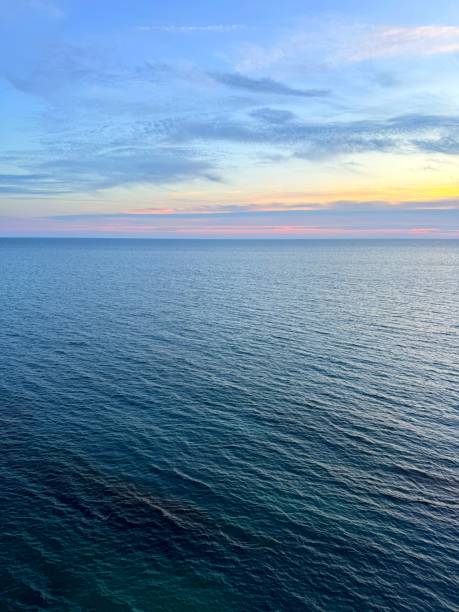 istock Sunrise sky above sea calm blue water 2174489280