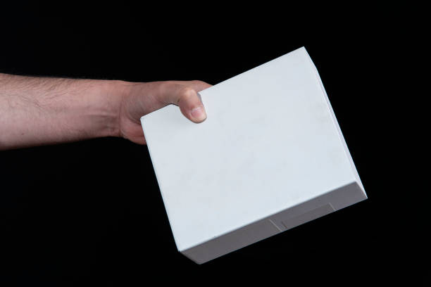istock Close-up of man's hand holding a large white cardboard box 2174489599