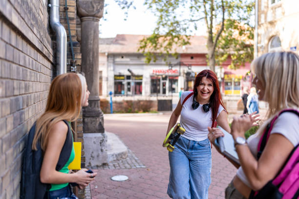 istock Friends joyfully greeting each other on the walkway. 2174493737