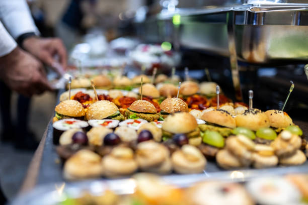 istock Assorted appetizers and gourmet sliders displayed at a catered event in an elegant venue during evening hours 2174502255