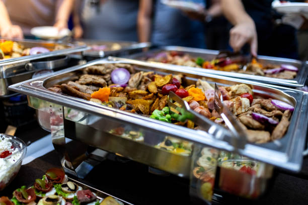 istock Buffet spread featuring assorted grilled meats and vegetables at a lively social gathering in the evening 2174502312