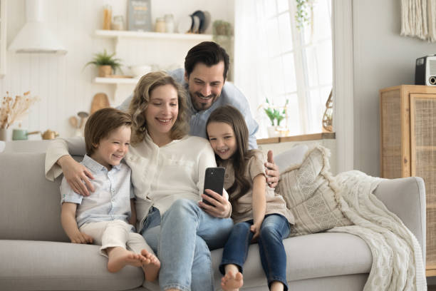 istock Family watching videos, have fun at home using cellphone 2174503211