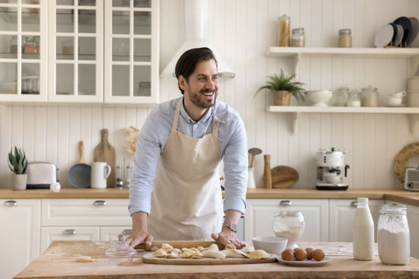 istock Handsome millennial man prepares pastries for family 2174503316