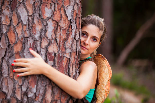 istock Young woman embracing a tree 2174503319