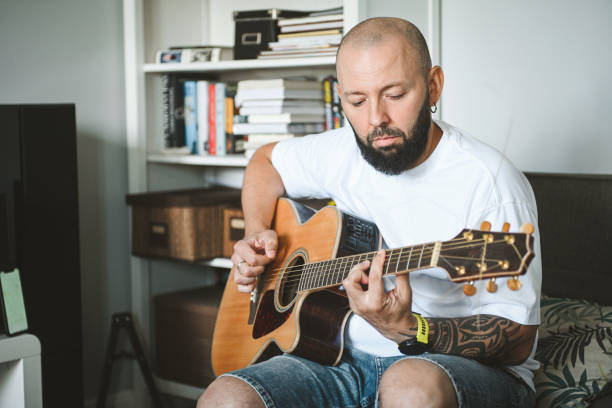 istock man plays the guitar and sings songs 2174504673