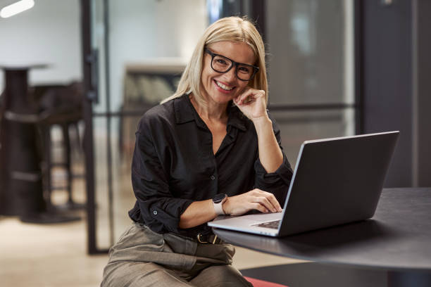 istock A Smiling Businesswoman is Working Efficiently on Her Laptop in a Modern Office Environment, 2174504959