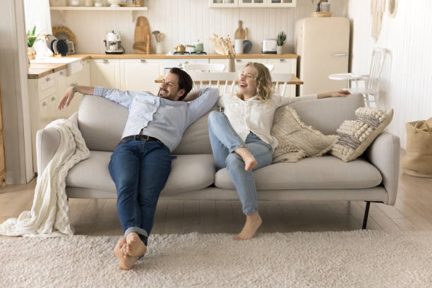 istock Happy spouses relax on cozy sofa at new house 2174505133