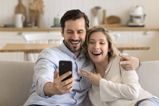 istock Happy couple make photo staring at gadget screen use cellphone 2174505523