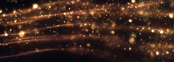 istock beautiful blurred gold background of dust particles and sparkles 2174505742