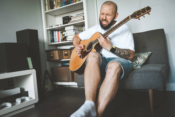 istock man plays the guitar and sings songs 2174506055
