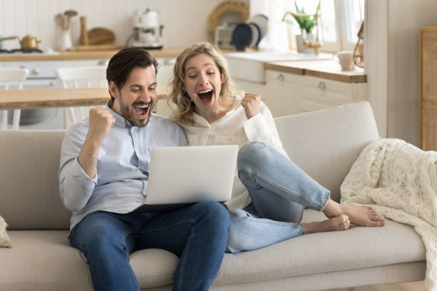 istock Overjoyed young couple celebrating on-line lottery win success 2174506114