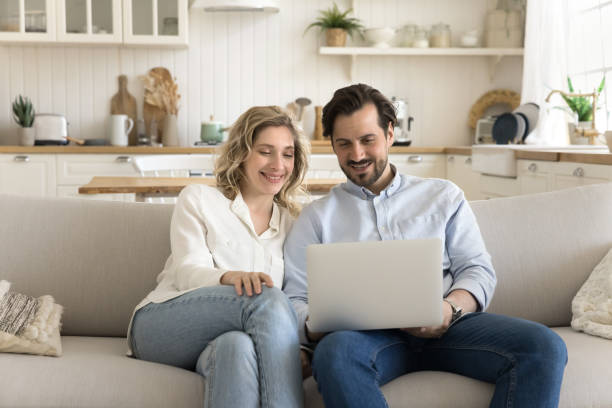 istock Millennial attractive couple watching movie on computer at home 2174506432