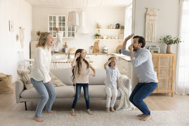 istock Excited parents dance with children at home 2174506697