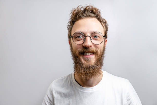 istock Handsome hipster man with beard smiling at camera over white background. 2174506793