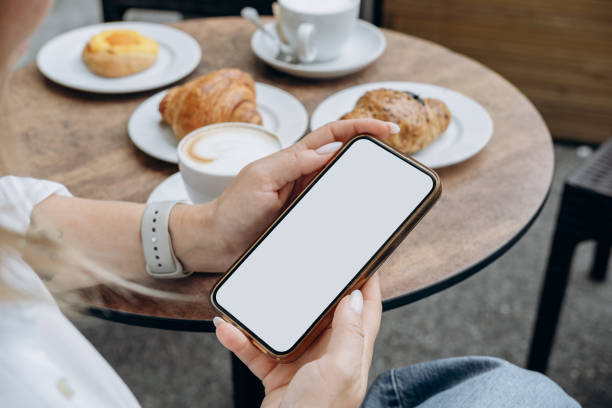 istock Mockup woman's hand holding using smart phone with white blank screen at coffee shop, mobile app design and advertising, online marketing 2174507657