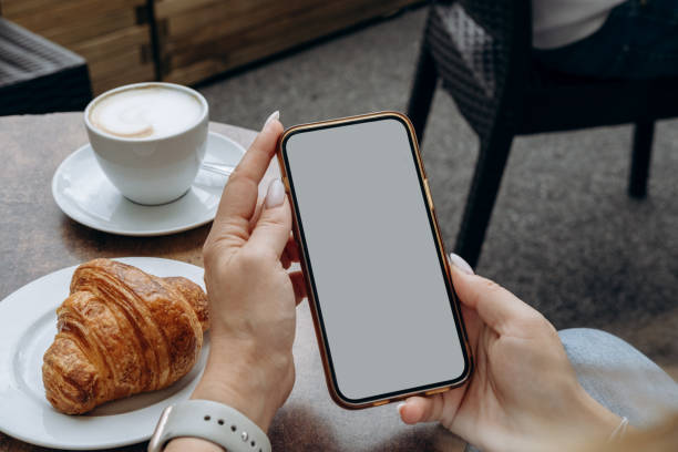 istock Mockup woman's hand holding using smart phone with white blank screen at coffee shop, mobile app design and advertising, online marketing 2174507704