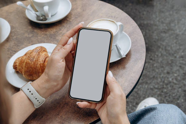 istock Mockup woman's hand holding using smart phone with white blank screen at coffee shop, mobile app design and advertising, online marketing 2174507722