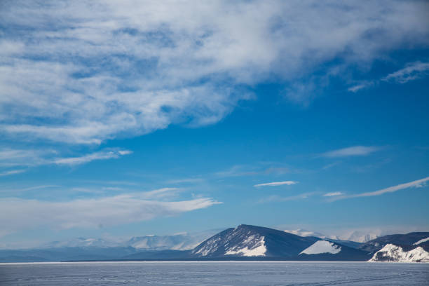 istock A snowy mountain looms against a blue sky filled with clouds 2174509183