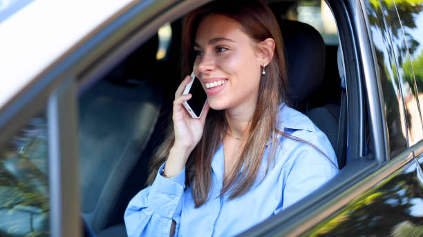 istock Young woman telephoning from her car 2174509375