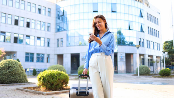 istock Woman on a journey using smartphone on the street 2174510040