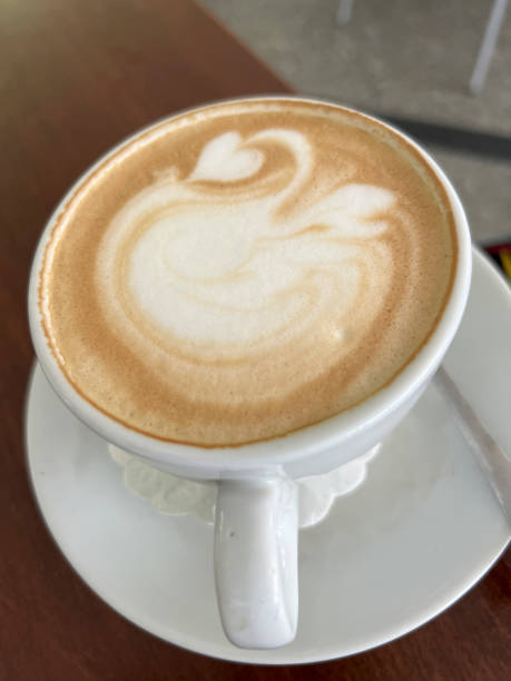 istock A cup of coffee with milk prepared so that a decorative pattern is created on the surface of the coffee 2174511844